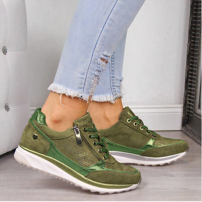 Grüne Damen-Sneaker aus Leder, sportlich, mit Reißverschluss, weiße Sohle, modisch.
