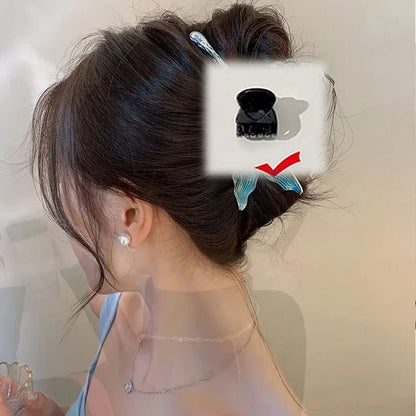 Frau mit braunem Dutt, verziert mit blauem Schmetterlings-Haarclip, eleganter Look.