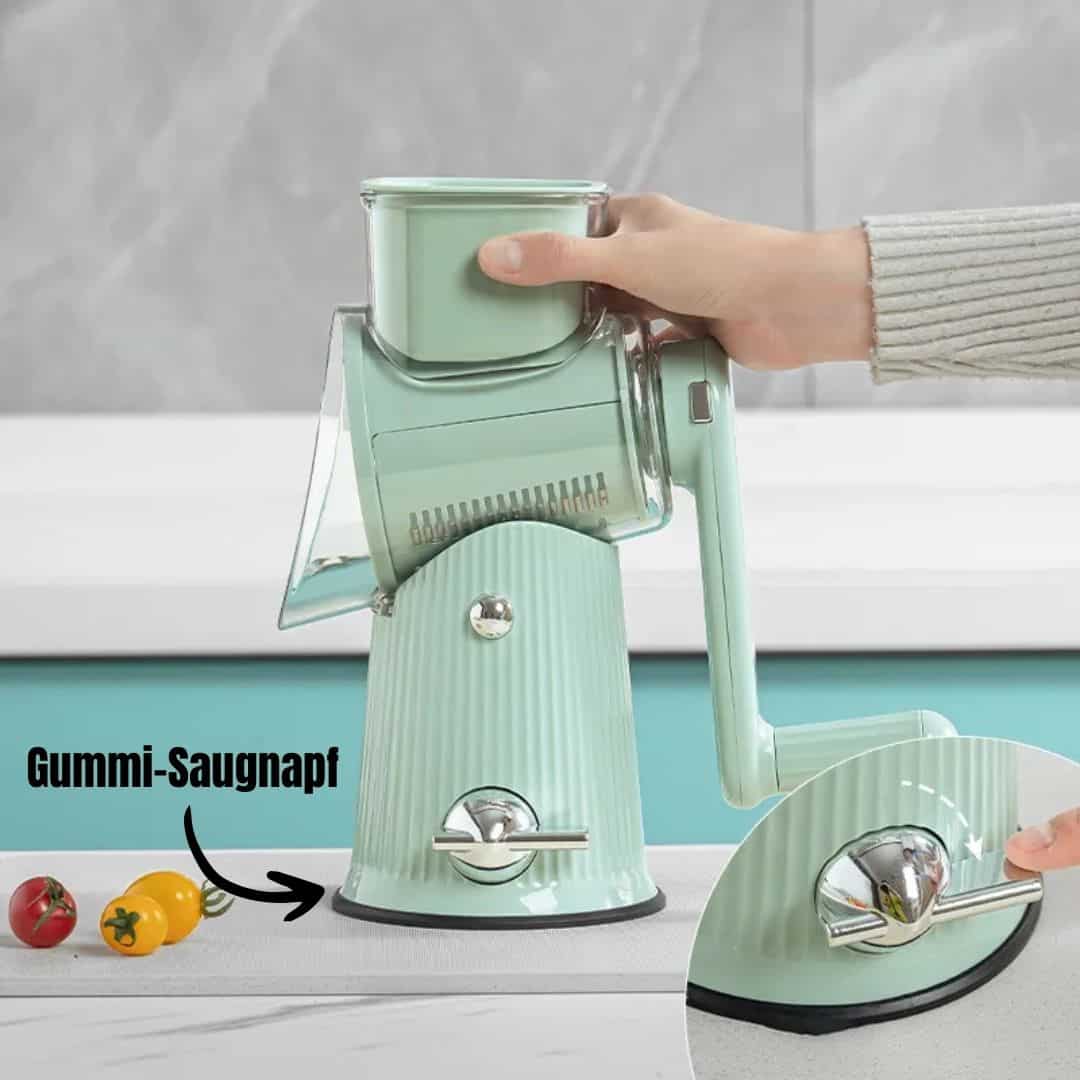 Handkurbel-Gemüseschneider mit Gummi-Saugnapf, mintgrün, auf Küchenarbeitsplatte.