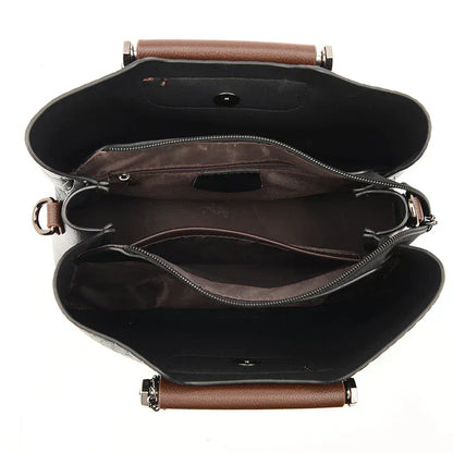 Schwarze Lederhandtasche mit braunen Griffen, Innenfächer, Reißverschluss, elegant, Damenmode.