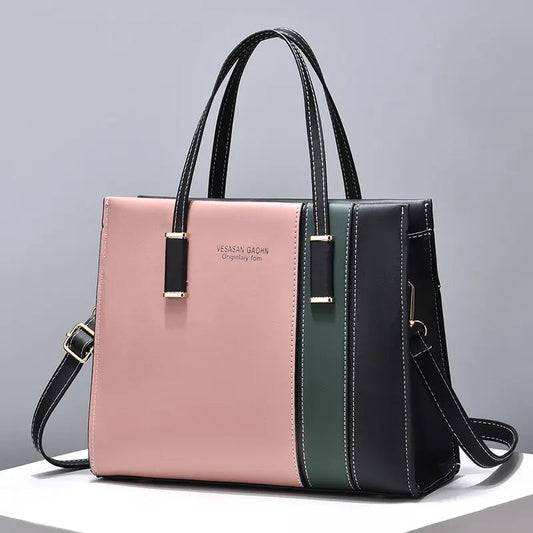 Damenhandtasche aus Leder, rosa und schwarz, mit Schulterriemen, elegant und modern.