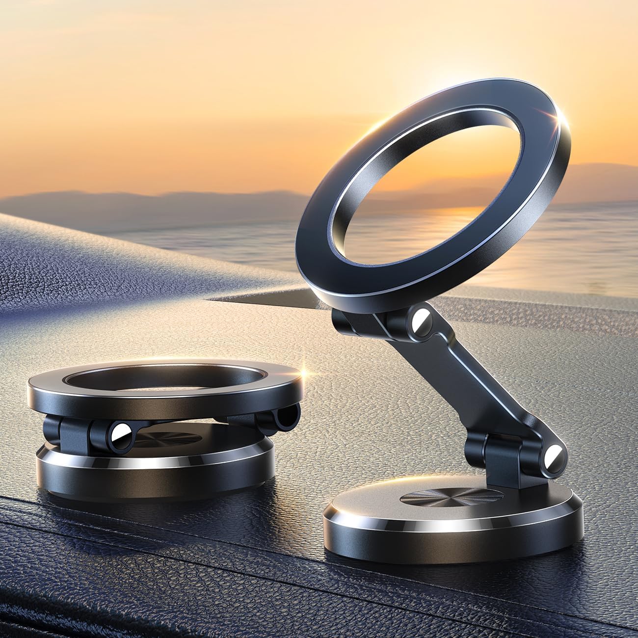 Zwei schwarze magnetische Handyhalterungen aus Metall auf Armaturenbrett im Sonnenuntergang.
