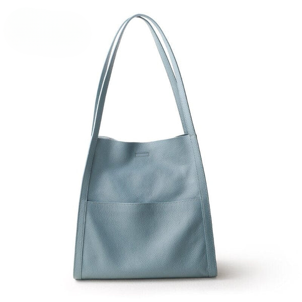 Hellblaue Ledertasche mit langen Henkeln, modisch, elegant, Damenhandtasche, Alltagsgebrauch.