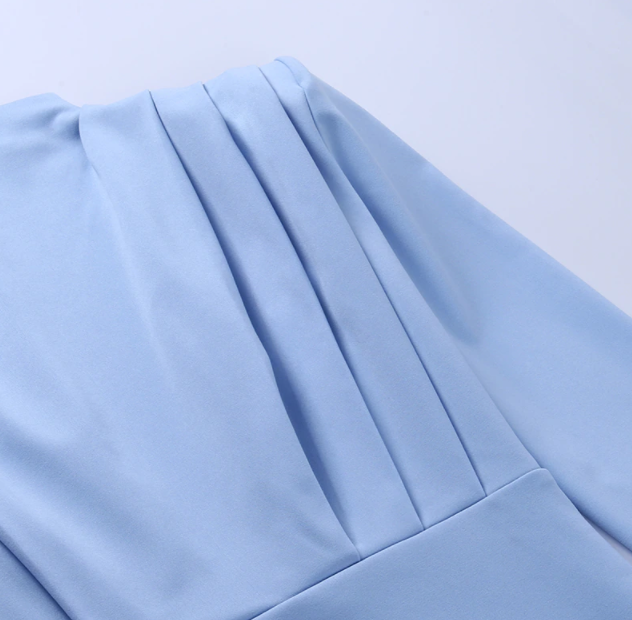 Hellblaues Kleid aus Baumwolle, Falten-Design, elegantes Damenmode-Detail, Nahaufnahme.