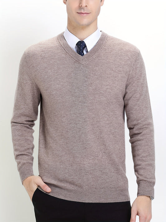 Mann im beigen V-Ausschnitt-Pullover, weißem Hemd, blauer Krawatte; elegante Herrenmode.