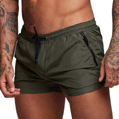 Grüne Herren-Badeshorts mit Reißverschlusstaschen, sportlich, schnell trocknend, elastischer Bund.