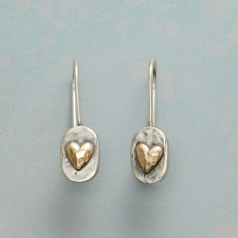 Silberne Ohrringe mit goldenen Herzanhängern, handgefertigter Schmuck, elegantes Design.