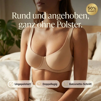 Kvinna i beige bh sitter i en sÀng med vita lakan och en grön vÀxt i bakgrunden, med informationsikoner. 1