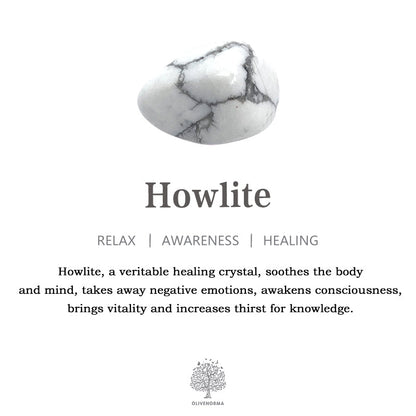 Howlith-Kristall weiß, graue Adern, Heilstein, Entspannung, Bewusstsein, Heilung, Olivenbaum-Logo.