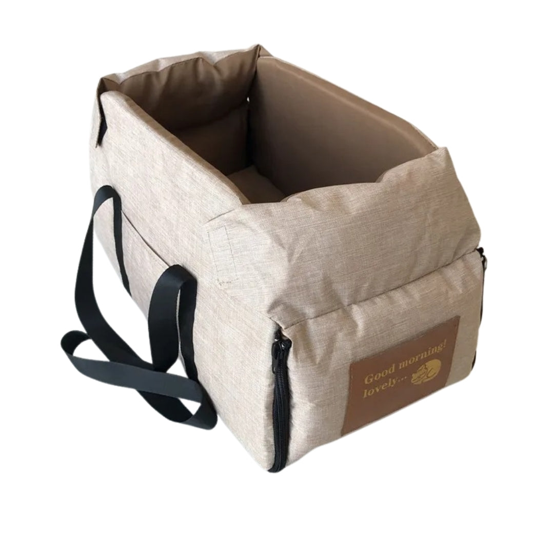 Beige Haustiertragetasche mit schwarzen Trägern, ideal für Hunde und Katzen, aus robustem Material.
