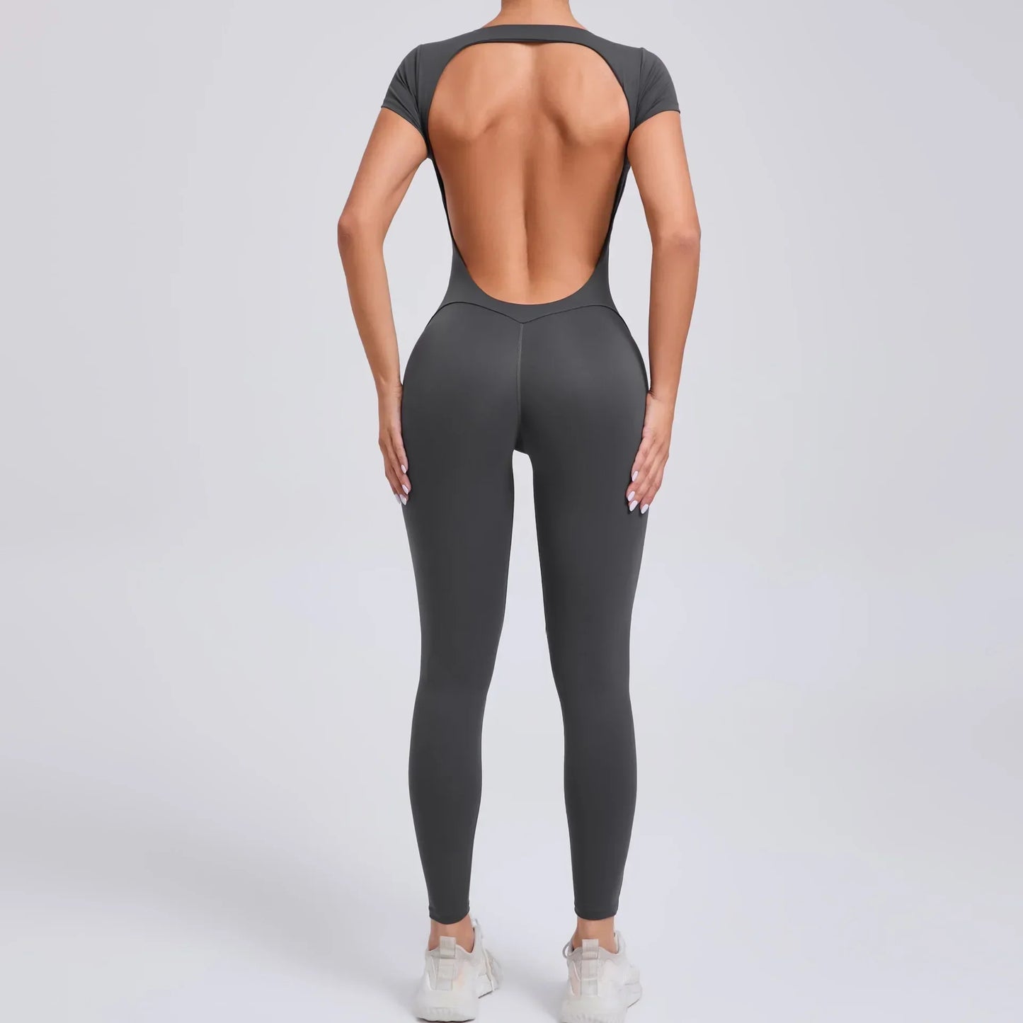 Damen-Overall, dunkelgrau, rückenfrei, figurbetont, Sportbekleidung, Fitnessmode.