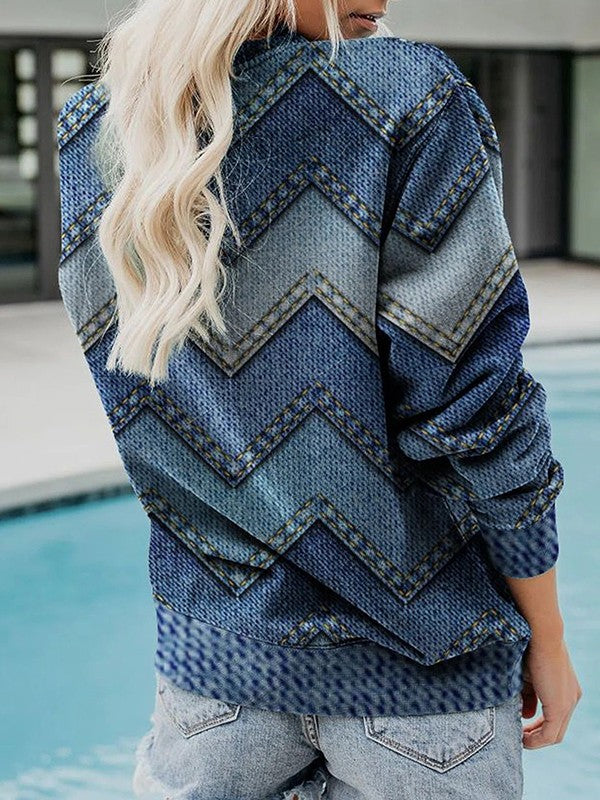 Frau in blauem Jeans-Pullover mit Zickzackmuster am Pool, modische Freizeitkleidung.