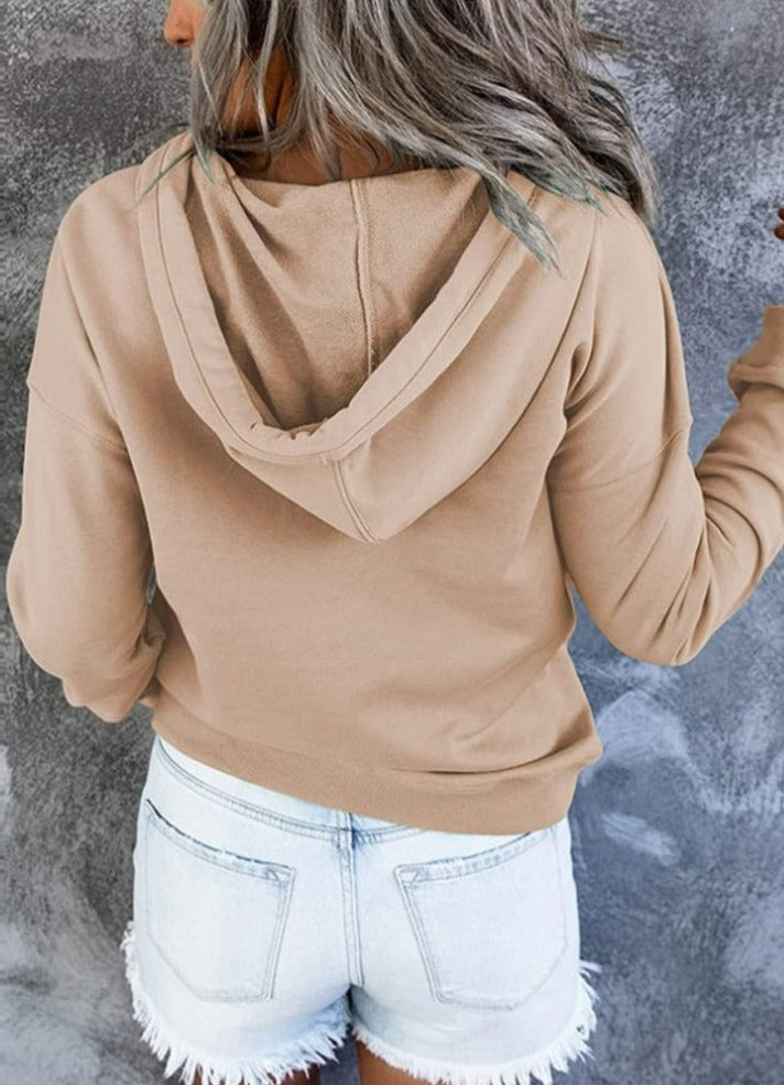 Frau in beige Kapuzenpullover und weißen Jeansshorts, Rückansicht, lässige Mode.
