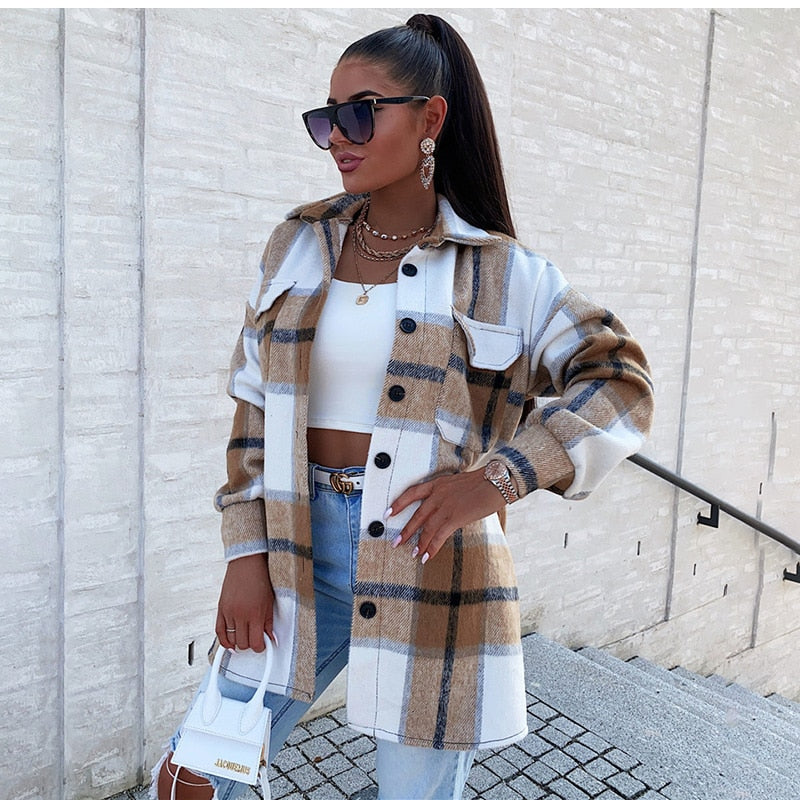 Frau in karierter Oversize-Jacke, weißem Top, Jeans, Sonnenbrille, Handtasche, modisch, urban.