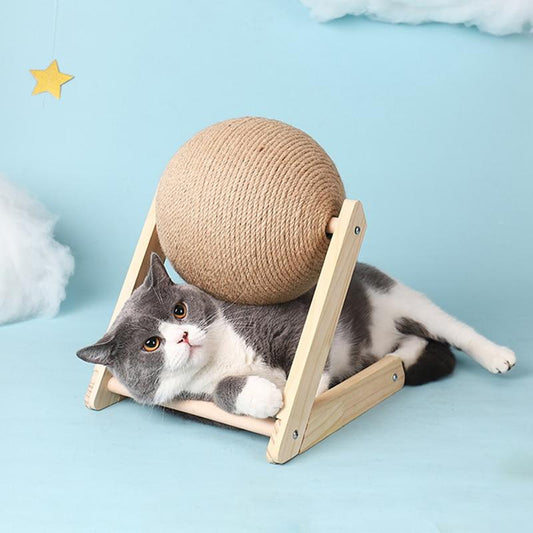 Graue Katze mit Kratzball aus Sisal auf Holzgestell, Spielzeug für Katzen, blauem Hintergrund.