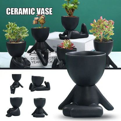 Schwarzer Keramik-Blumentopf in Menschenform, ideal für Sukkulenten, modernes Design.