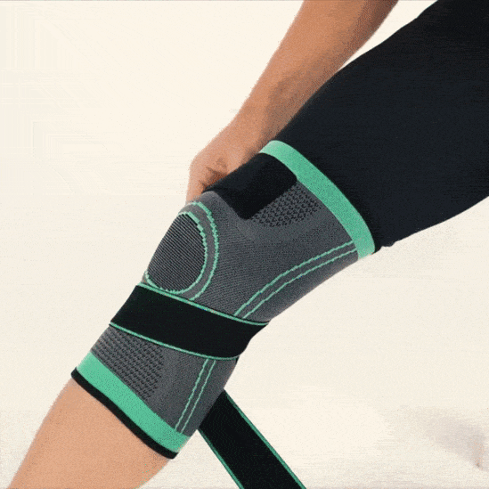 Person trägt graue Kniebandage mit grünen Akzenten, Kompressionsstütze für Sport und Erholung.
