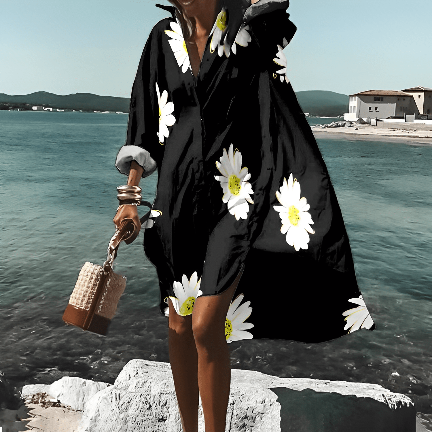 Frau in schwarzem, geblümtem, knielangem Kleid am Meer, Sommermode, Elle Vire.