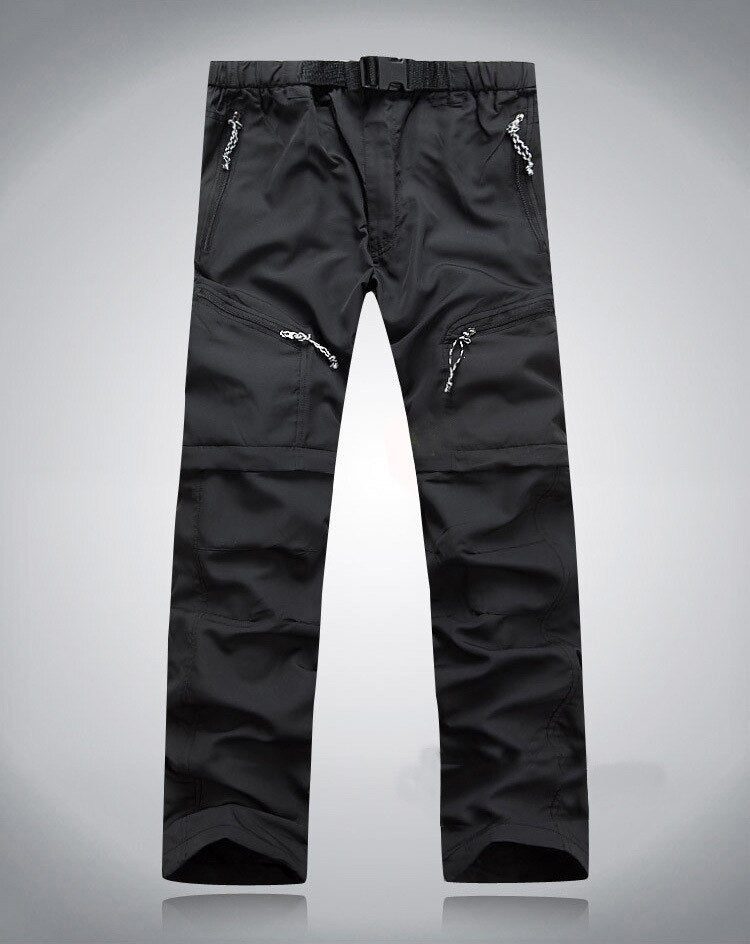 Schwarze Outdoor-Performance-Hose mit Reißverschlusstaschen und verstellbarem Bund.