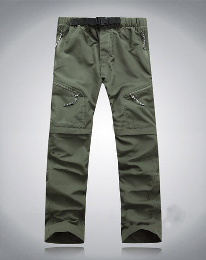Grüne Outdoor-Hose, elastisch, mit Reißverschlusstaschen, ideal für Wandern und Trekking.
