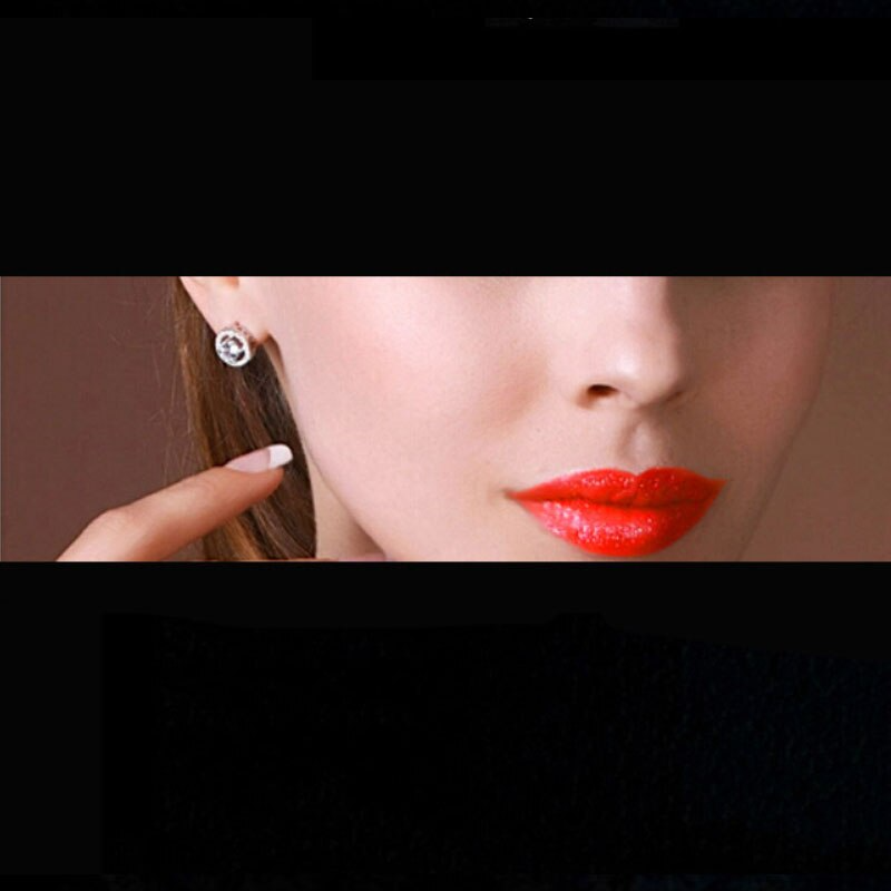 Frau mit roten Lippen trägt silberne Kristall-Ohrringe, eleganter Schmuck, Hochzeit, Geschenk.