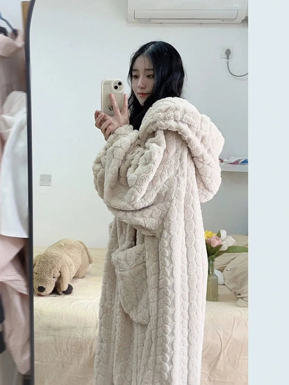 Frau im beigen, flauschigen Bademantel mit Kapuze, Selfie im Schlafzimmer, gemütliche Mode.