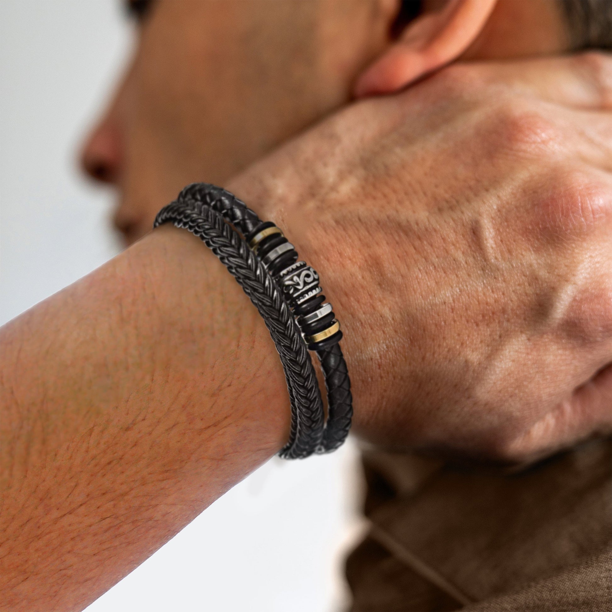 Schwarzes Lederarmband für Herren, geflochten, mit silbernen Details, modisches Accessoire.
