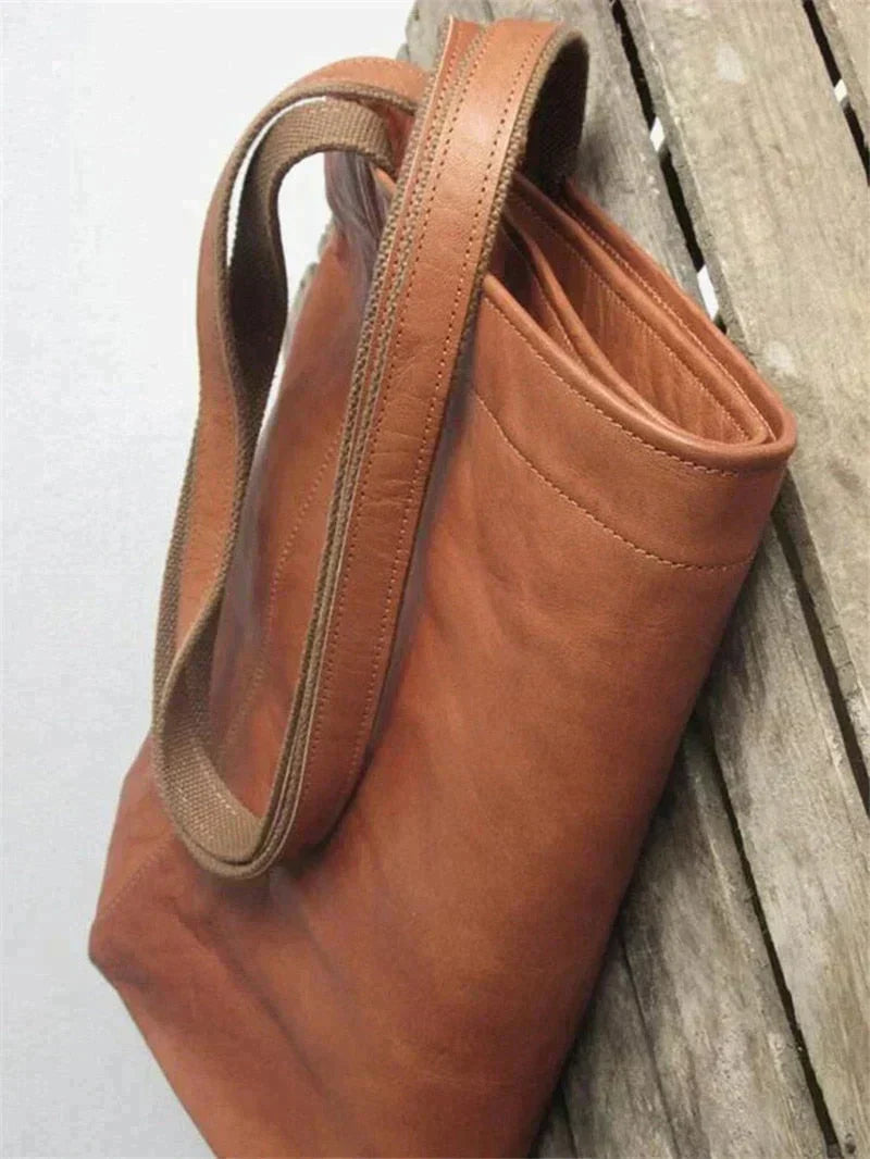Braune Ledertasche mit robustem Griff, langlebig, elegant, Damenmode Accessoire.