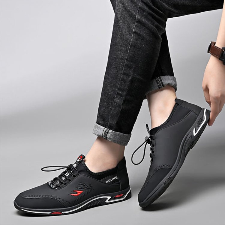 Schwarze Herrenschuhe, stilvoll und bequem, mit rotem Detail, ideal für Freizeitkleidung.