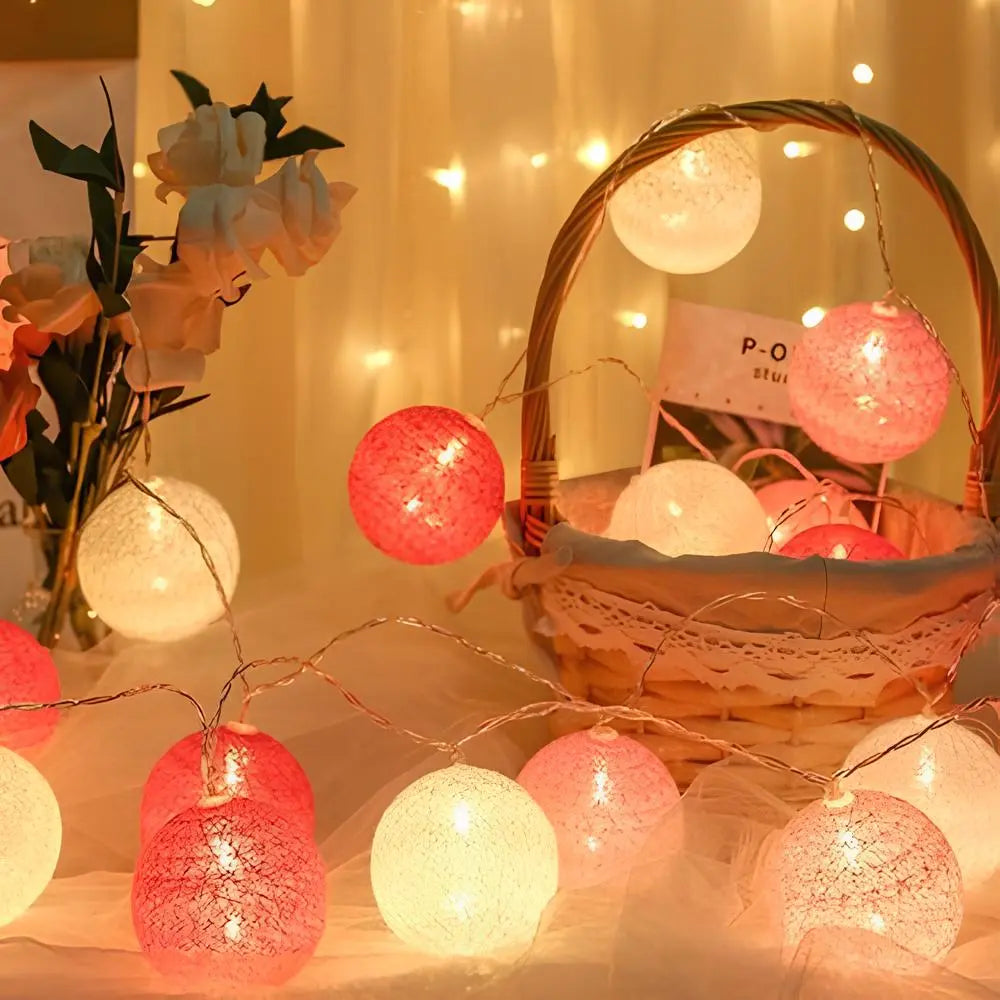 Rosa und weiße LED-Lichterkette in Korb, dekorative Beleuchtung, gemütliche Atmosphäre.