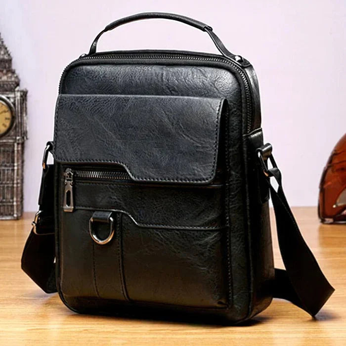 Schwarze Lederschultertasche, modern, stilvoll, mit Reißverschluss und verstellbarem Riemen.