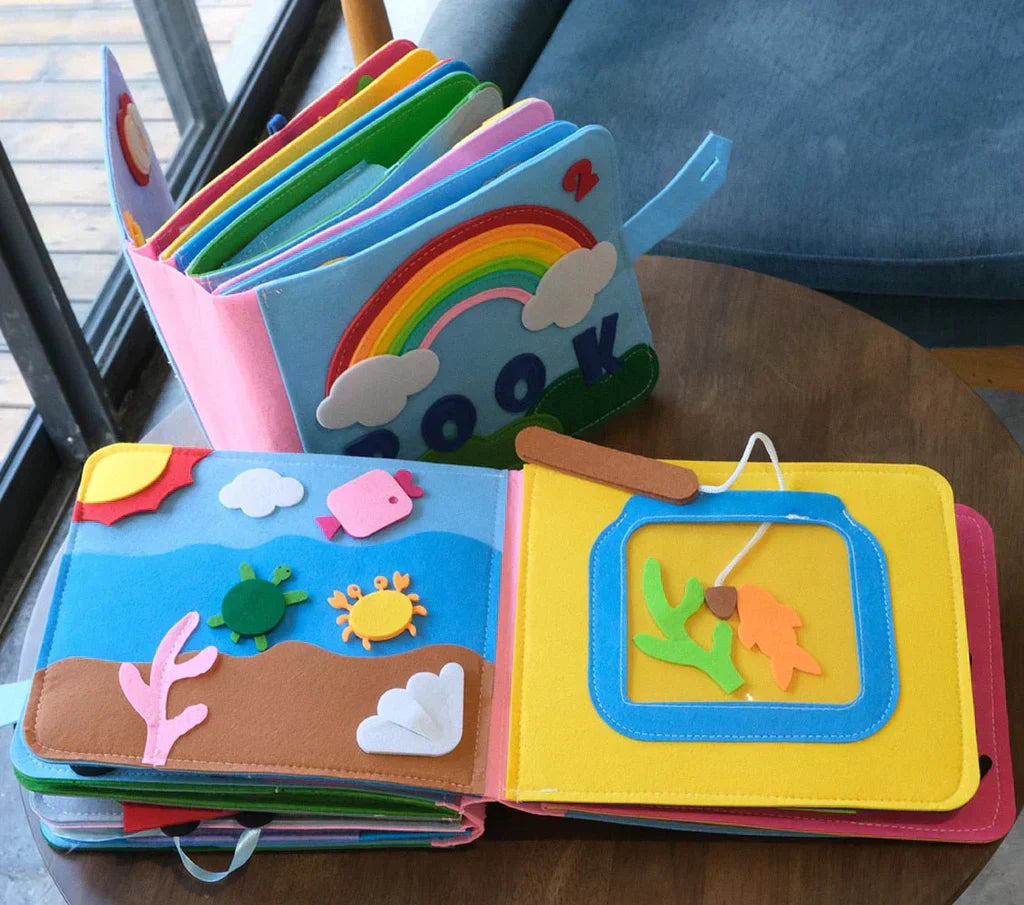 Montessori Stoffbuch für Kinder, bunt, interaktiv, Lernspielzeug, pädagogisch, Regenbogenmotiv.