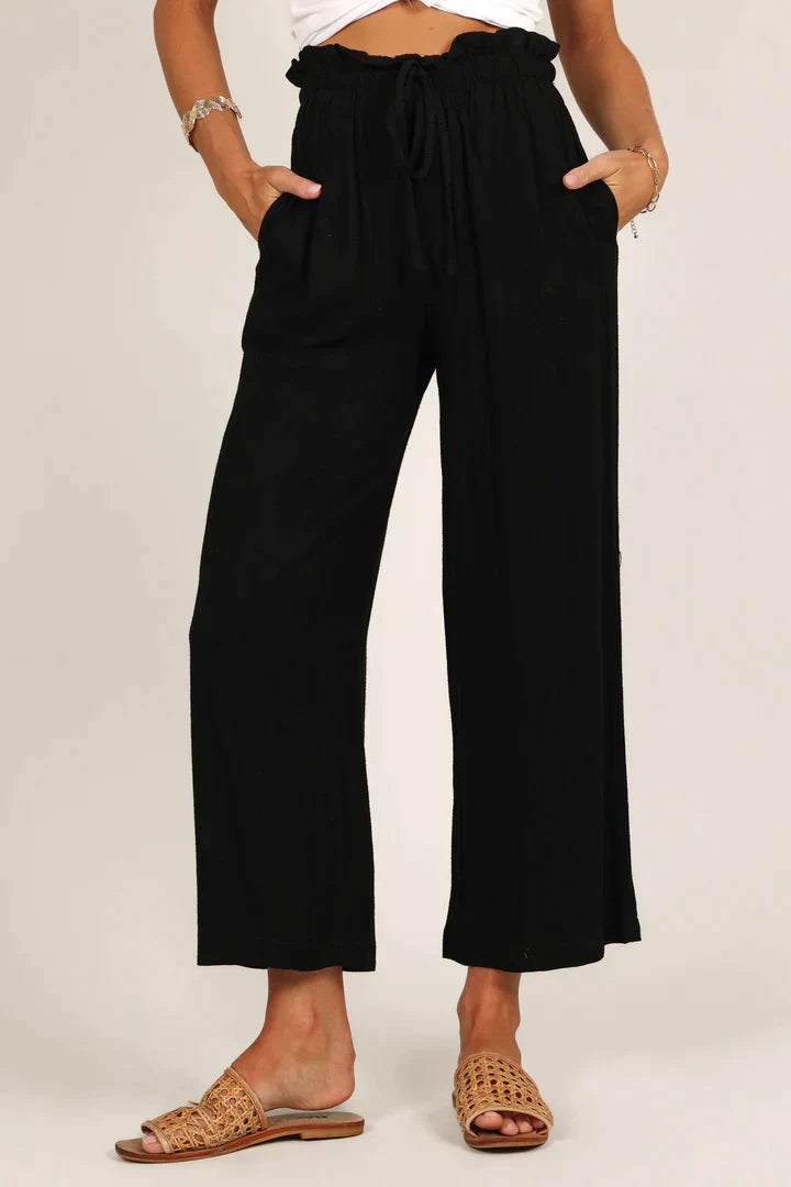 Schwarze Damenhose, locker geschnitten, mit Kordelzug, aus Baumwolle, modisch und bequem.