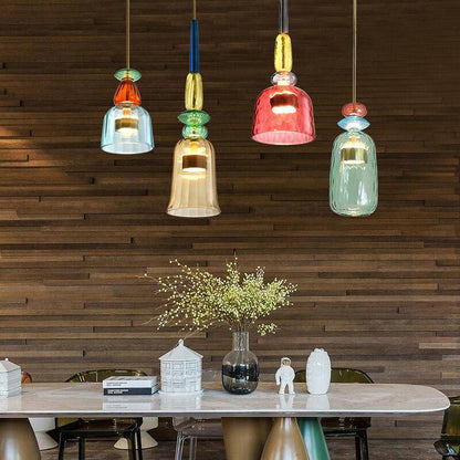 Bunte Glas-Pendelleuchten über modernem Esstisch, Holzverkleidung, stilvolle Inneneinrichtung.