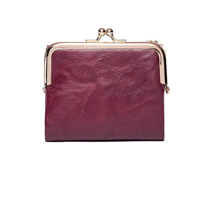 Lila Leder-Geldbörse mit Metallrahmen, Vintage-Stil, Damen Accessoire, elegant und modisch.