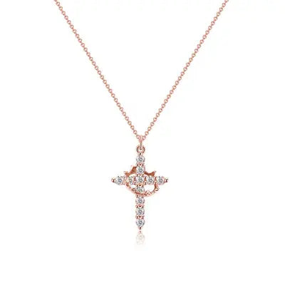 Roséguldfärgat halsband med korshänge med glittrande stenar och en liten krona, fotograferat framifrån på vit bakgrund. 5