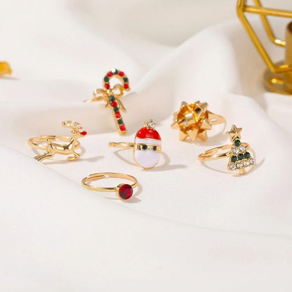 Weihnachtliche Ringe Set, goldfarben, mit Weihnachtsbaum, Rentier, Zuckerstange, Santa-Motiv.