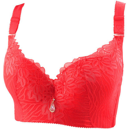 Roter Spitzen-BH mit Blumenmuster, verstellbaren Trägern und Schmuckanhänger.