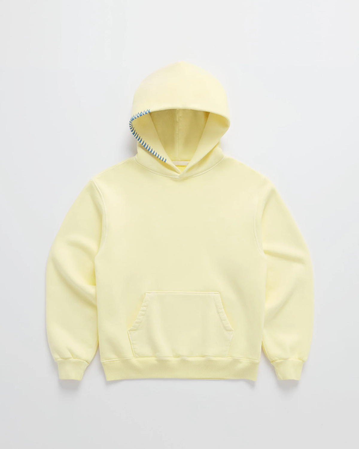 Ljusgul hoodie sedd framifrån mot vit bakgrund, med känguruficka, ribbade muddar och blå dekorsöm längs ena huvkanten. 1