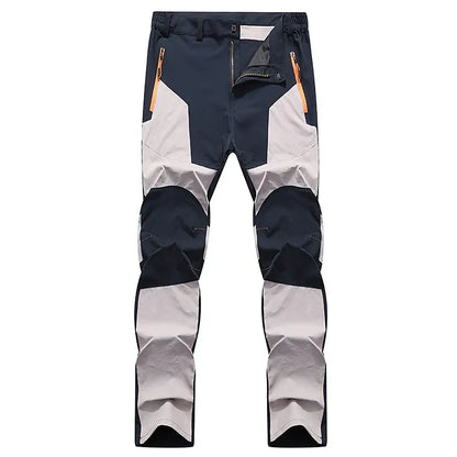 Wasserdichte Outdoor-Hose, schwarz-grau, mit Reißverschlusstaschen, ideal für Wandern und Trekking.